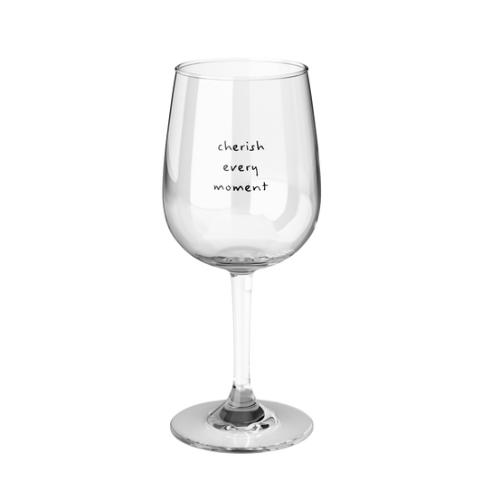 a clear wine glass printed with cherish every moment in black